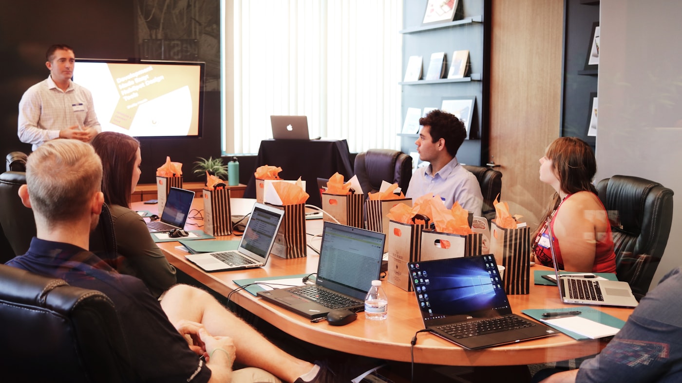 SMB business team at whiteboard reviewing cyber insurance controls and remediation plan